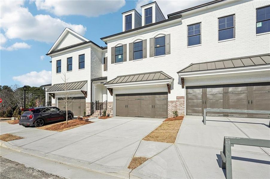Front exterior of a new home in Millcroft Townhomes, Buford, GA, highlighting curb appeal (Image 1). Front exterior of a new home in Millcroft Townhomes, Buford, GA, highlighting curb appeal (Image 1).