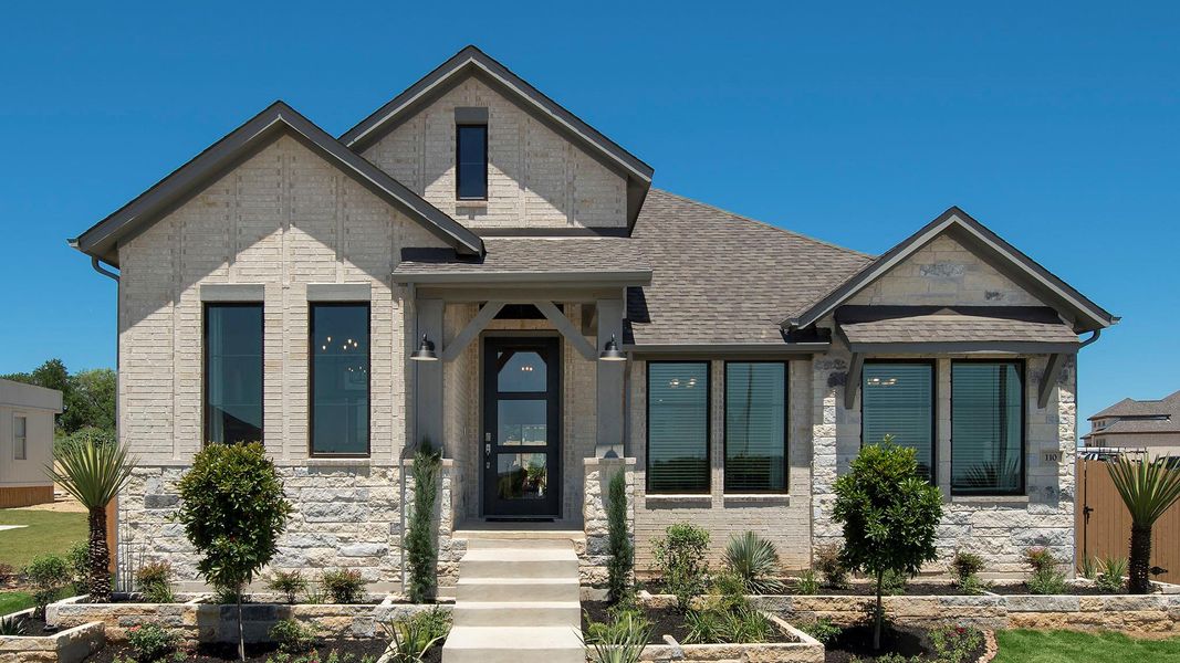 View of front of house with a shingled roof and stone siding View of front of house with a shingled roof and stone siding