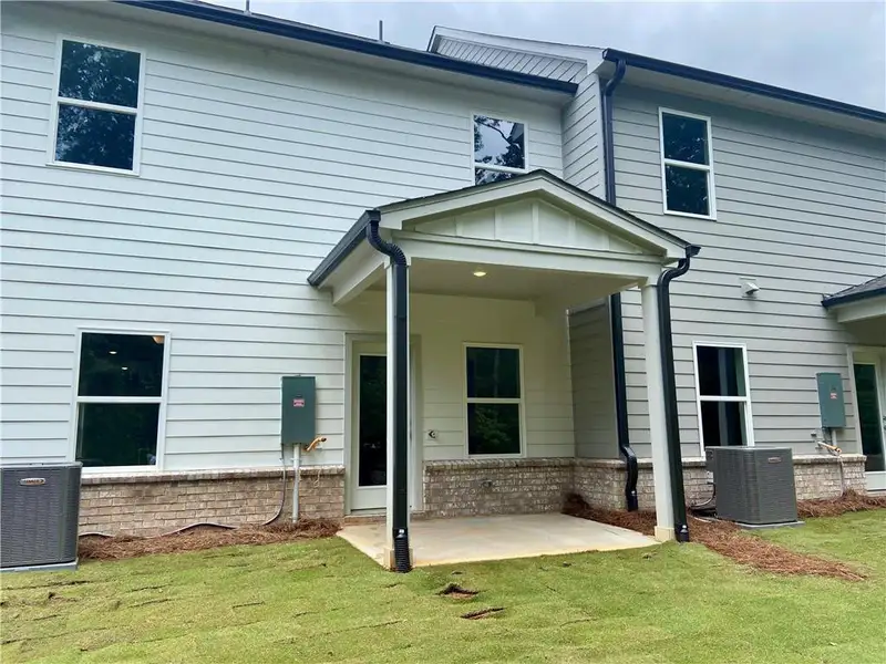 Exterior details and patio area of a home in Eastlyn Crossing, Flowery Branch (Image 4).