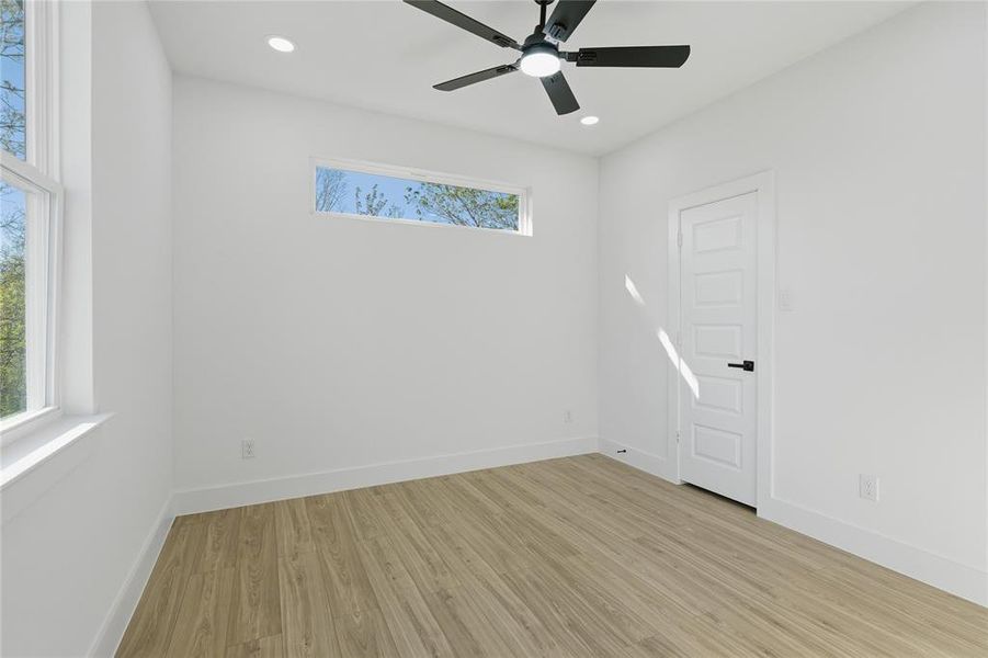 Unfurnished room featuring light wood-type flooring, a ceiling fan, and recessed lighting Unfurnished room featuring light wood-type flooring, a ceiling fan, and recessed lighting