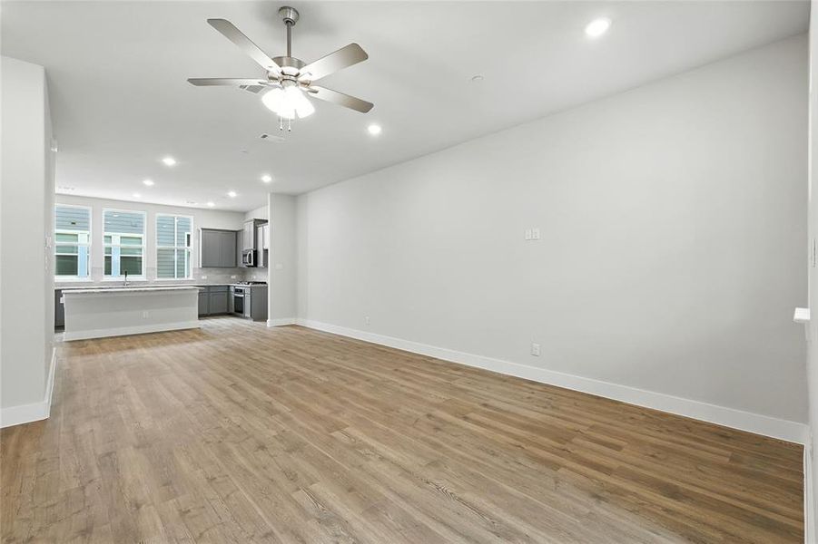 Unfurnished living room with recessed lighting, light wood-style flooring, and a ceiling fan