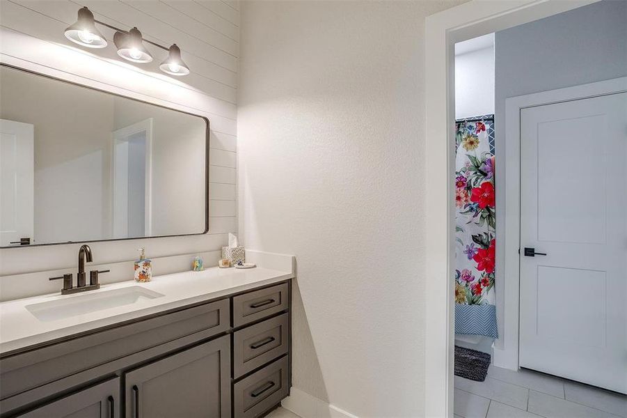 Bathroom with vanity and tile patterned flooring