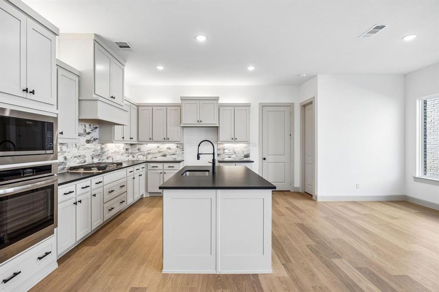 Gorgeous cabinetry, beautiful countertops and designer backsplash paired with contemporary stainless steel create a kitchen for the ages. Gorgeous cabinetry, beautiful countertops and designer backsplash paired with contemporary stainless steel create a kitchen for the ages.