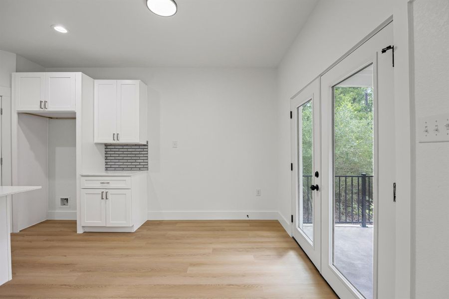Unfurnished dining area featuring light wood finished floors and recessed lighting Unfurnished dining area featuring light wood finished floors and recessed lighting