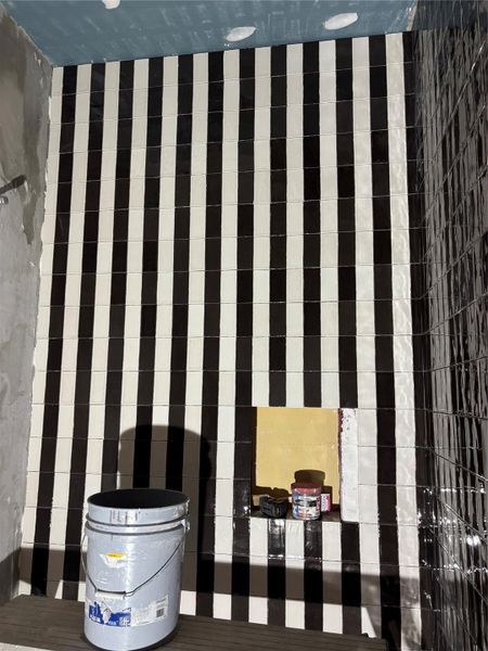 Bold and timeless bathroom design featuring striking black and white striped tilework