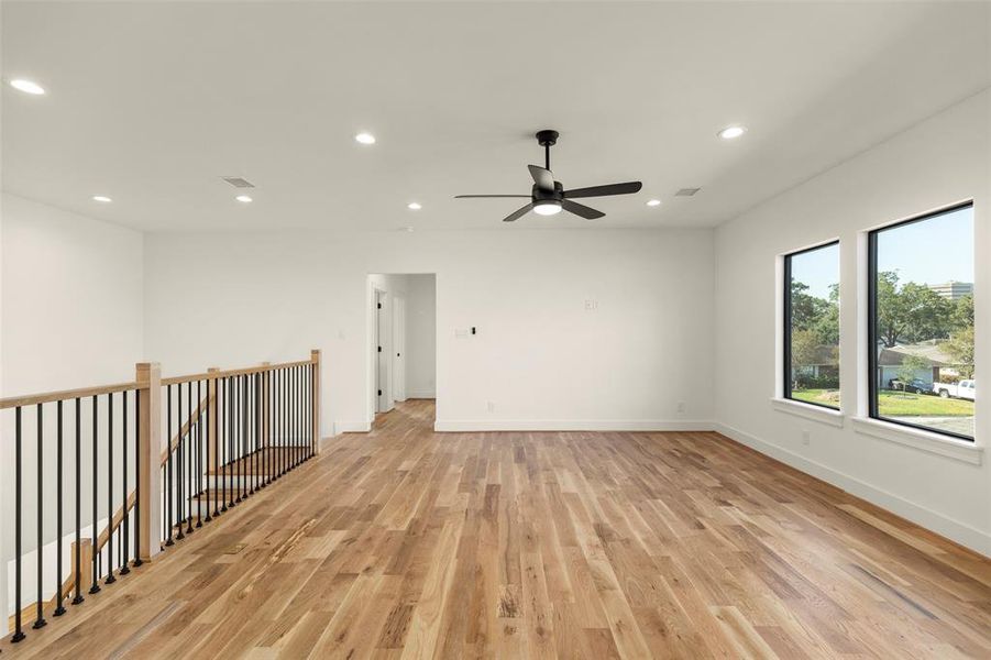 open concept game room, plenty of natural light, recessed lighting, white oak floors accentuate this livable design