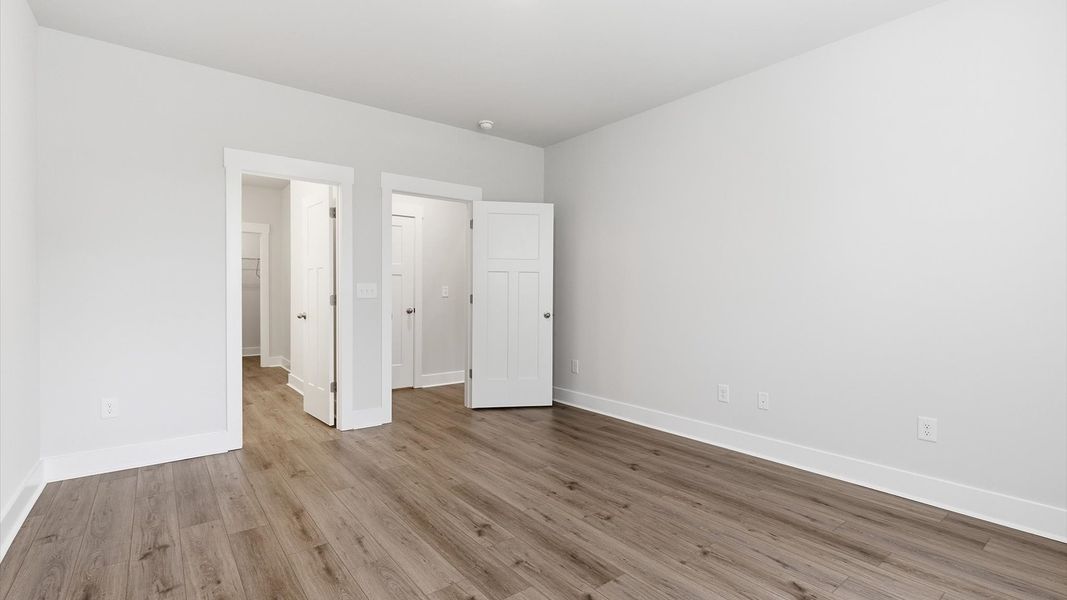 Eye-catching details and elegant finishes in the vibrant primary suite of this select home at Village at Midway Eye-catching details and elegant finishes in the vibrant primary suite of this select home at Village at Midway