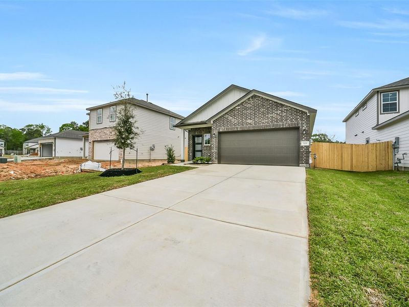 Front exterior of a new home in Caney Creek Place, Conroe, TX, highlighting curb appeal (Image 21).