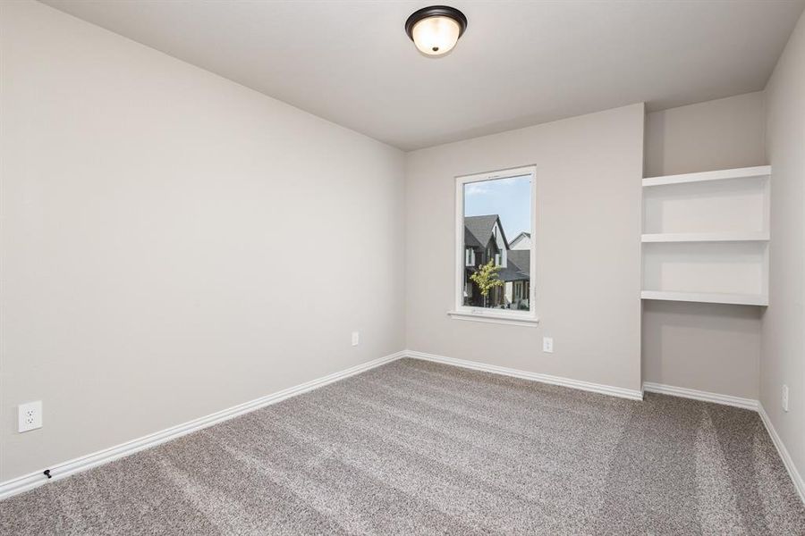 Spare room featuring carpet and baseboards