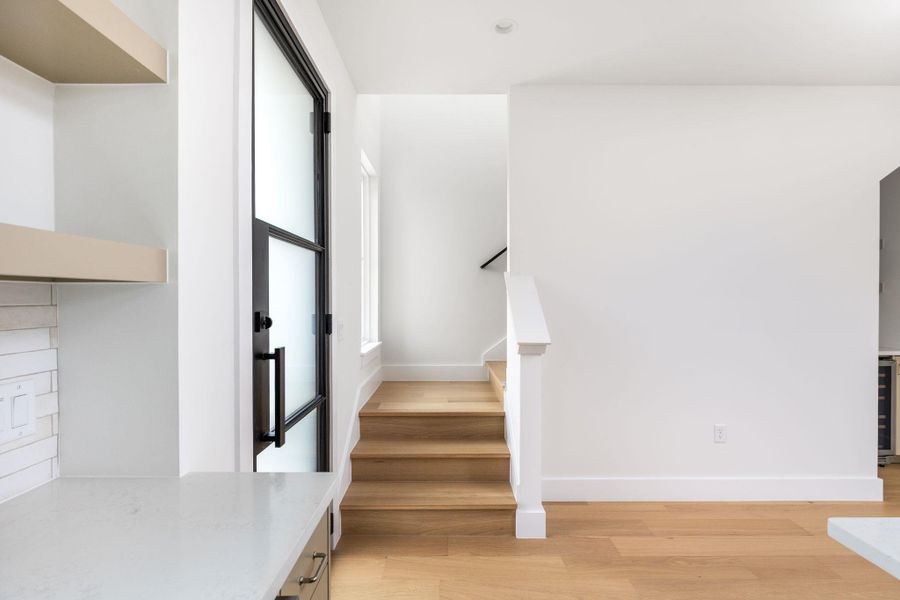 Stairs with wood finished floors and beverage cooler