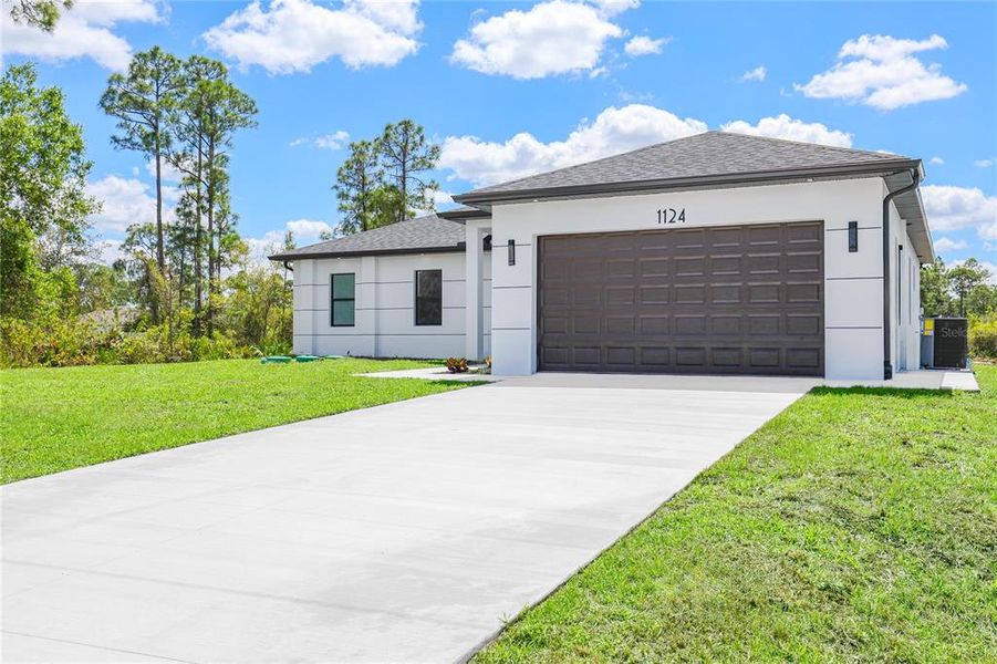 Front exterior of a new home in , Lehigh Acres, FL, highlighting curb appeal (Image 2). Front exterior of a new home in , Lehigh Acres, FL, highlighting curb appeal (Image 2).