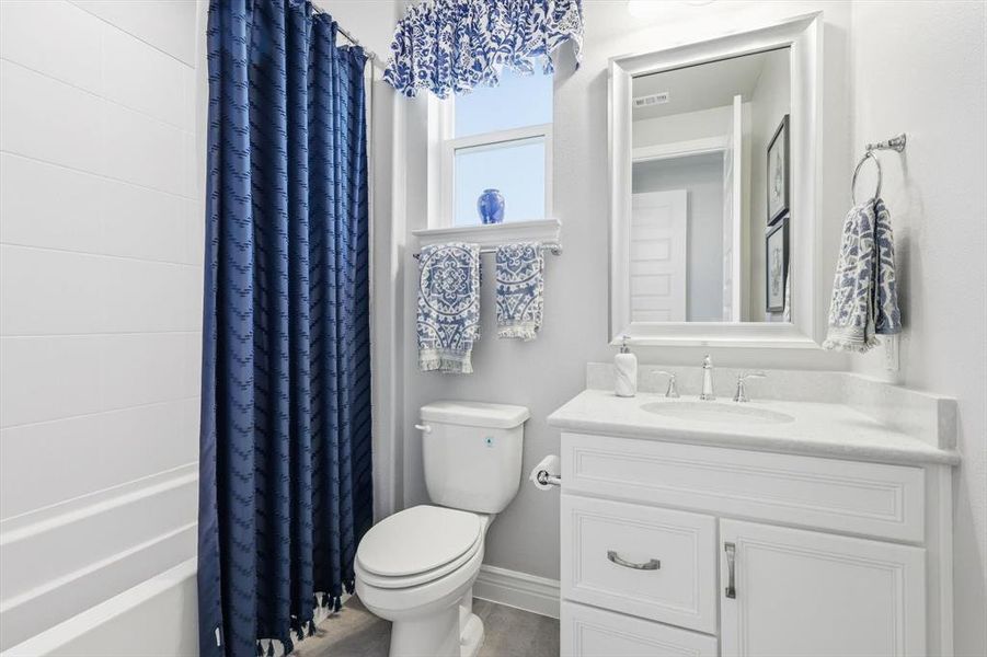 Bathroom featuring vanity and shower / tub combo