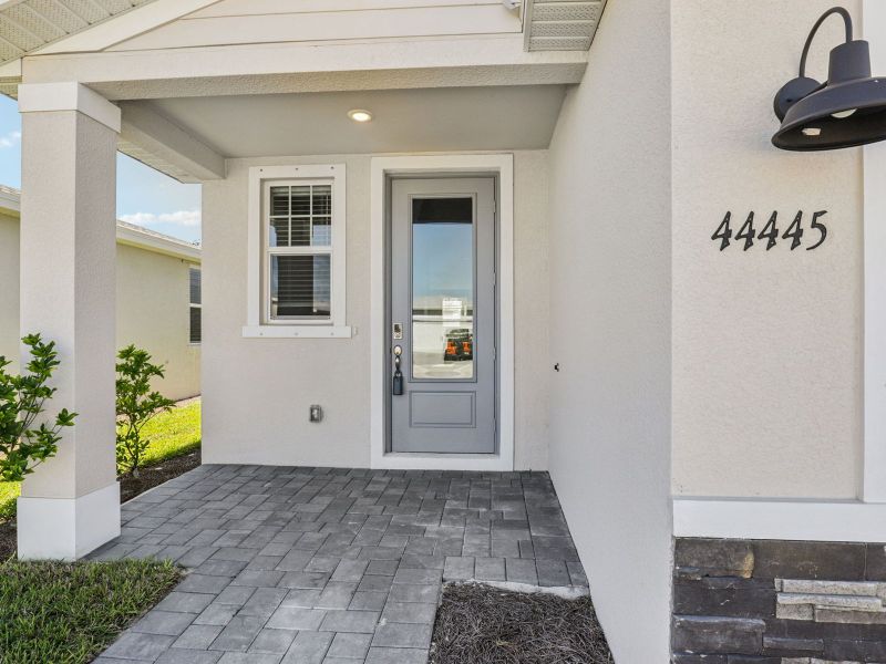 Exterior details and patio area of a home in Crescent Lakes - Premier Series, Punta Gorda (Image 3).