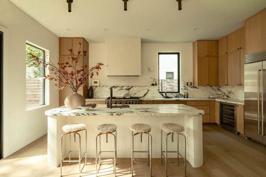 Slim shaker style cabinets with beautiful "Monet" Italian marble countertop with backsplash and plaster buildout venthood