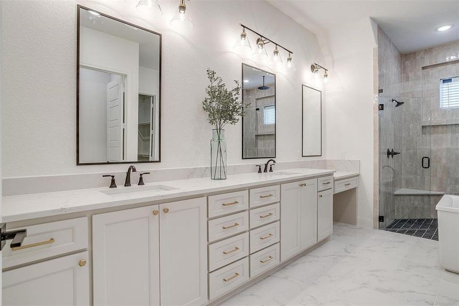 Bathroom featuring dual vanity, tile patterned floors, and an enclosed shower