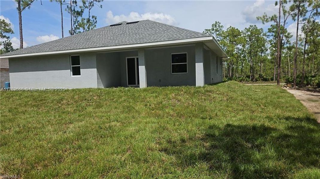Front exterior of a new home in , Lehigh Acres, FL, highlighting curb appeal (Image 12).
