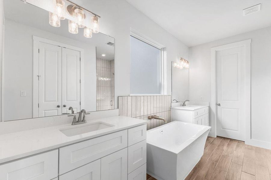 Elegant freestanding soaking tub and dual vanities define this tranquil bathroom retreat. Elegant freestanding soaking tub and dual vanities define this tranquil bathroom retreat.