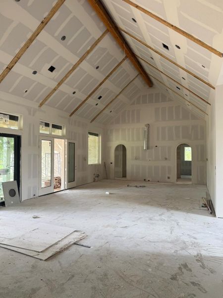 Miscellaneous room featuring high vaulted ceiling and arched walkways