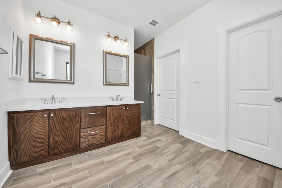 Double vanity sink and stand up shower in primary bedroom
