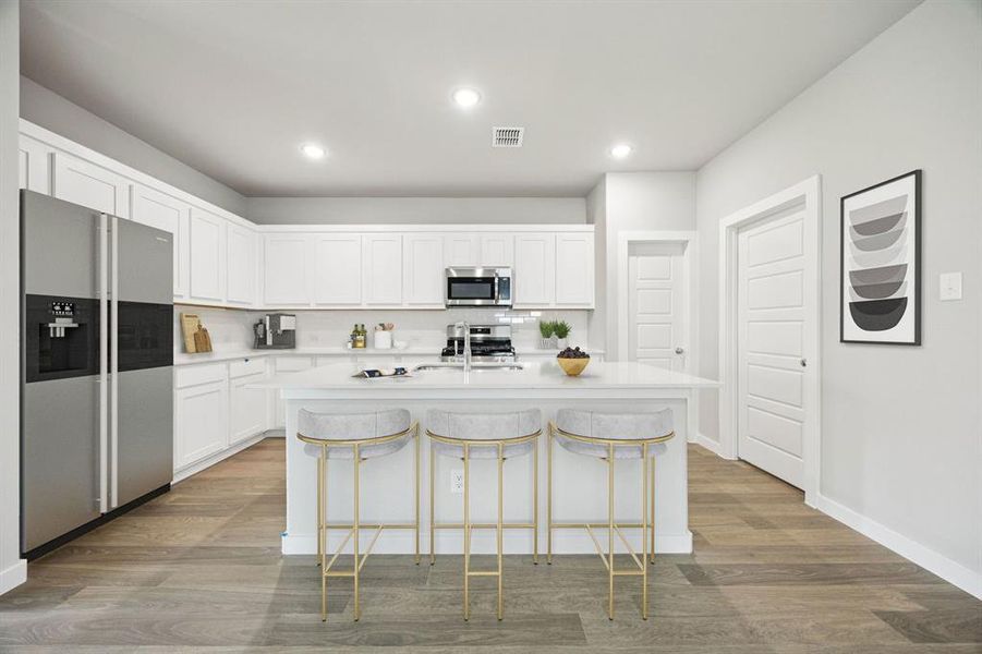 Kitchen in the Hayden home plan by Trophy Signature Homes – REPRESENTATIVE PHOTO