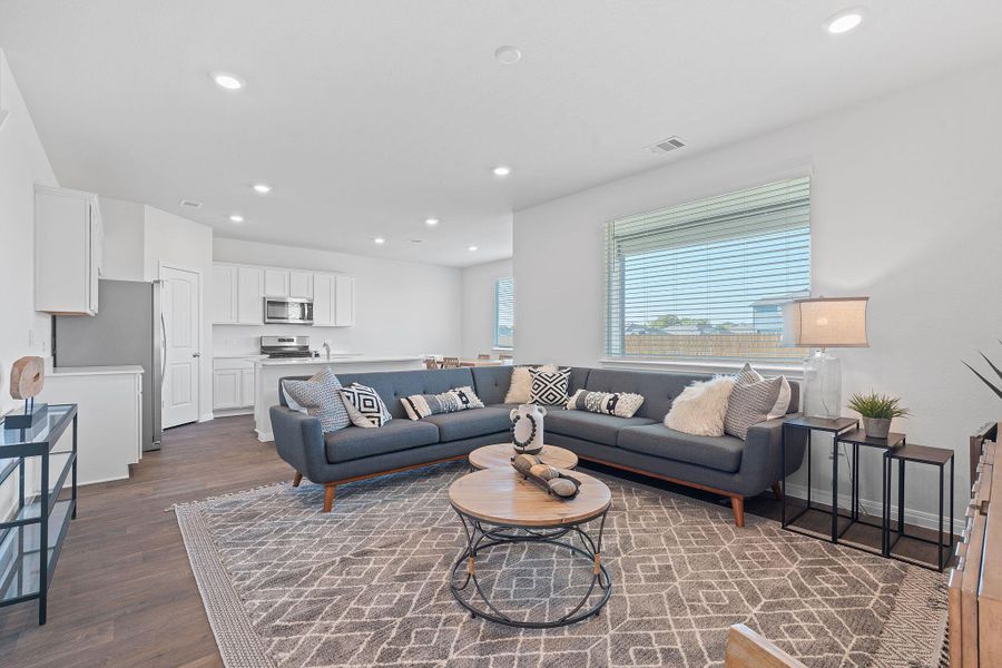 Living area with recessed lighting and dark wood-style flooring Living area with recessed lighting and dark wood-style flooring