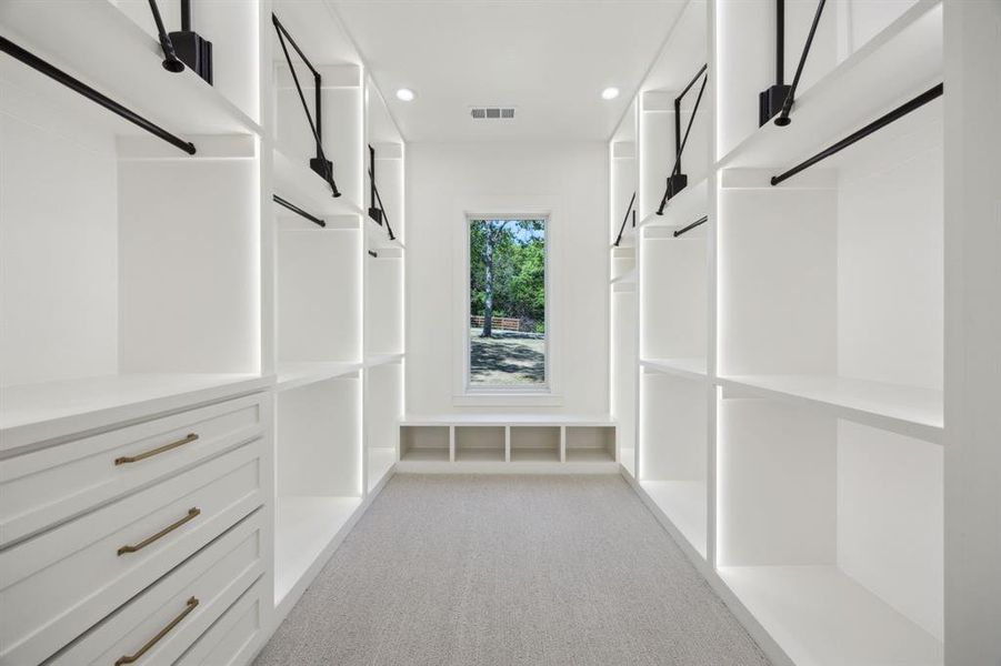 Walk in closet with visible vents and light carpet Walk in closet with visible vents and light carpet