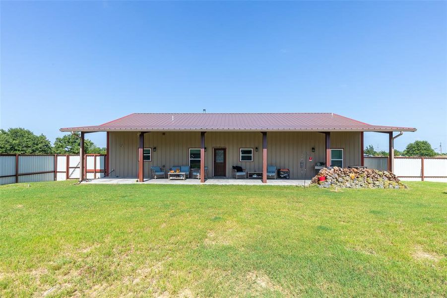 Expansive rear patio featuring a durable metal roof and supporting columns Expansive rear patio featuring a durable metal roof and supporting columns
