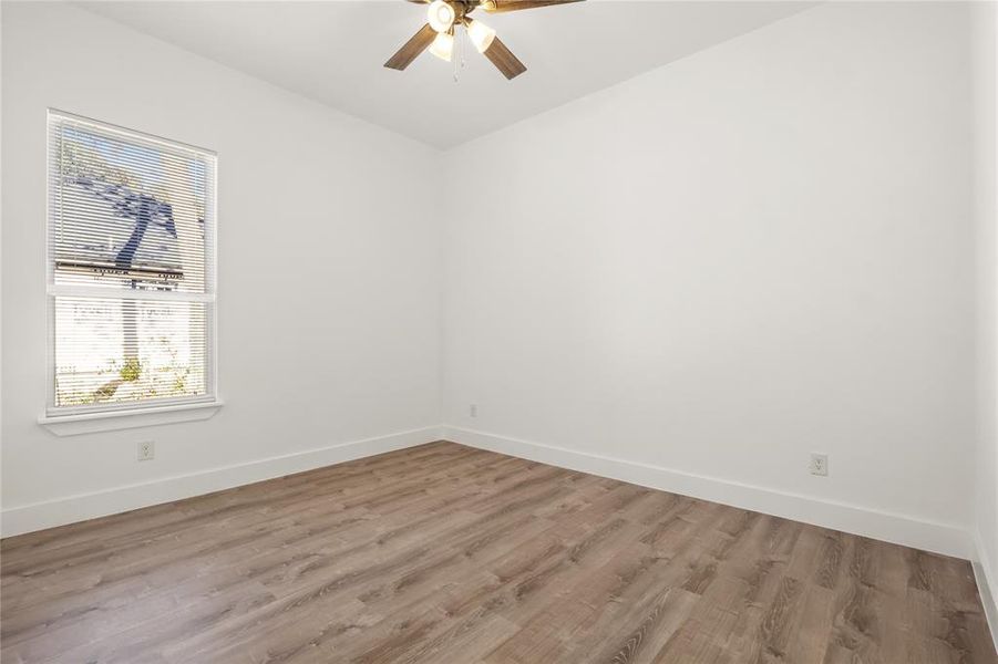 Spare room with ceiling fan and light hardwood / wood-style flooring