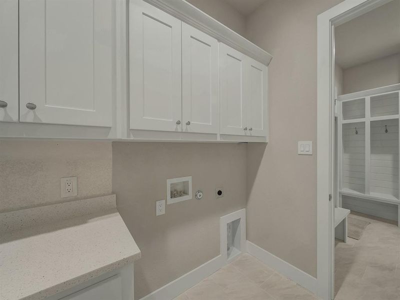 Laundry area featuring cabinet space, hookup for an electric dryer, gas dryer hookup, and hookup for a washing machine Laundry area featuring cabinet space, hookup for an electric dryer, gas dryer hookup, and hookup for a washing machine