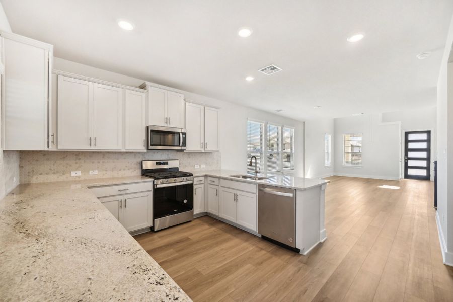 Kitchen and entry in the Medina floorplan at a Meritage Homes community.