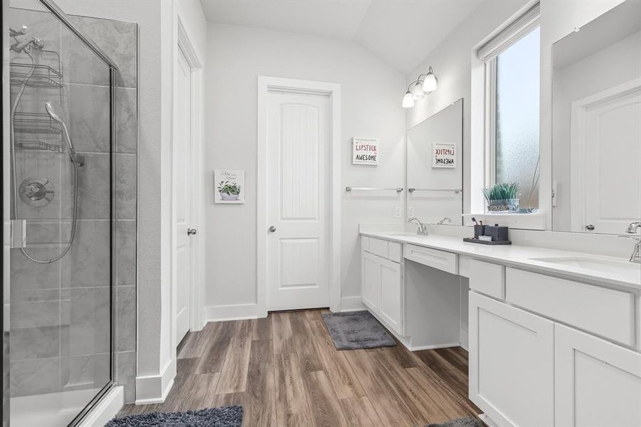 Full bathroom with a shower stall, double vanity, and dark wood-style floors Full bathroom with a shower stall, double vanity, and dark wood-style floors