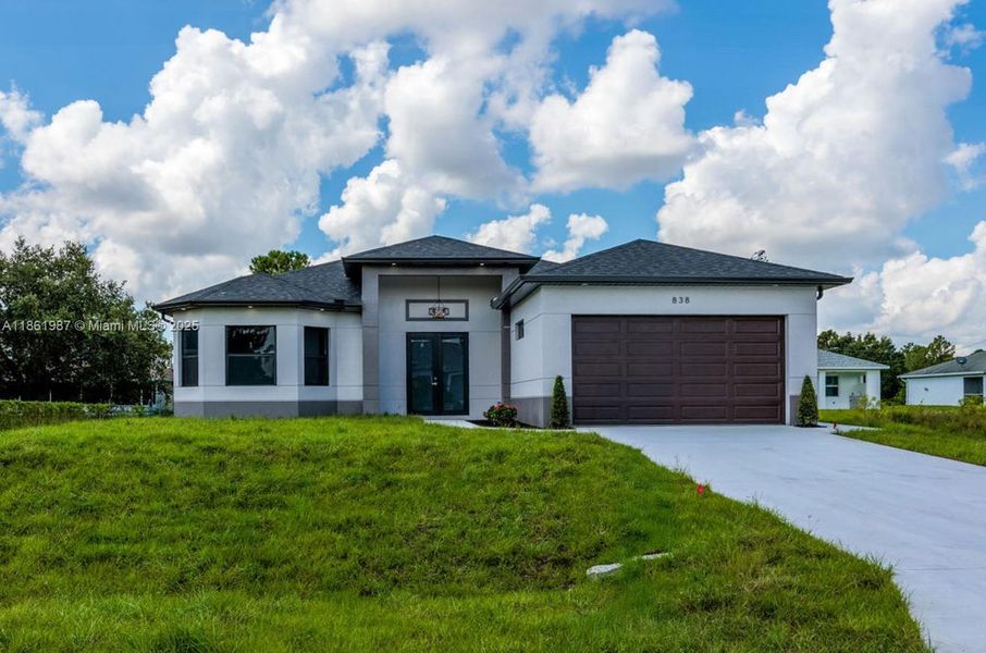 Front exterior of a new home in , Lehigh Acres, FL, highlighting curb appeal (Image 24). Front exterior of a new home in , Lehigh Acres, FL, highlighting curb appeal (Image 24).