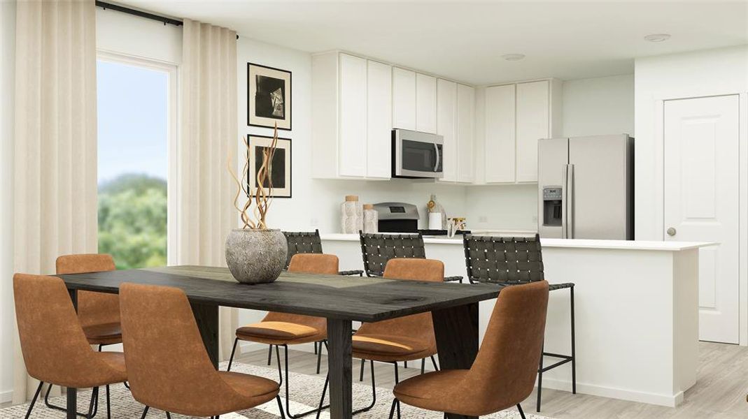 Dining space with light hardwood / wood-style floors