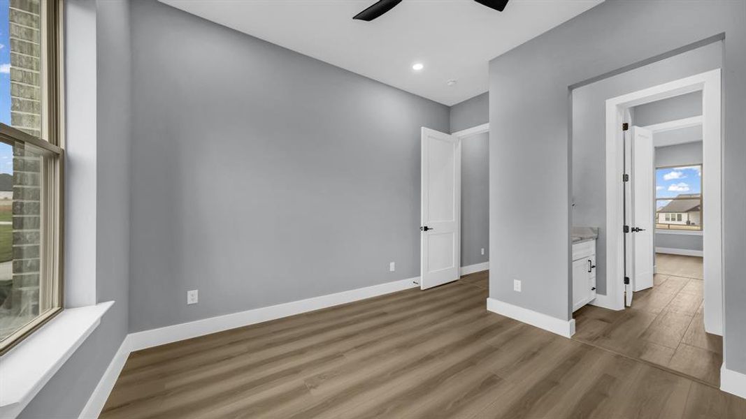 Unfurnished bedroom featuring wood finished floors, a ceiling fan, and recessed lighting