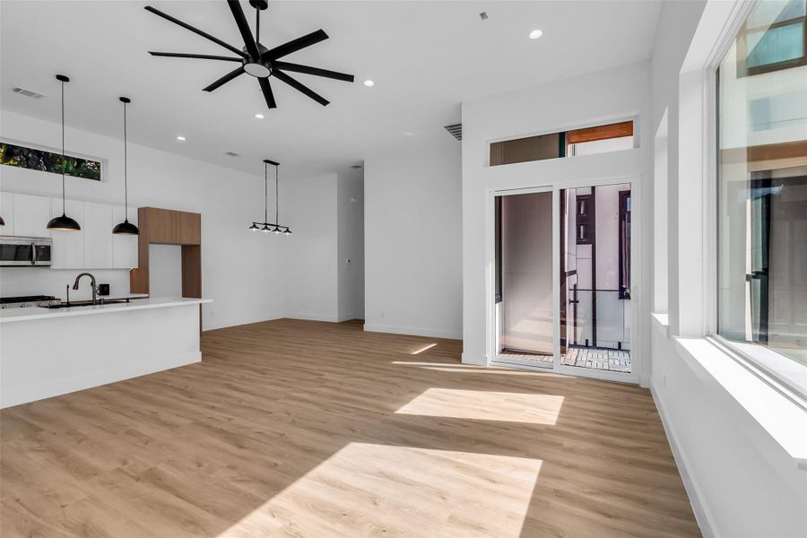 This additional view of the kitchen, dining, and living areas highlights the sunlight streaming through the windows, brightening the entire space. This additional view of the kitchen, dining, and living areas highlights the sunlight streaming through the windows, brightening the entire space.