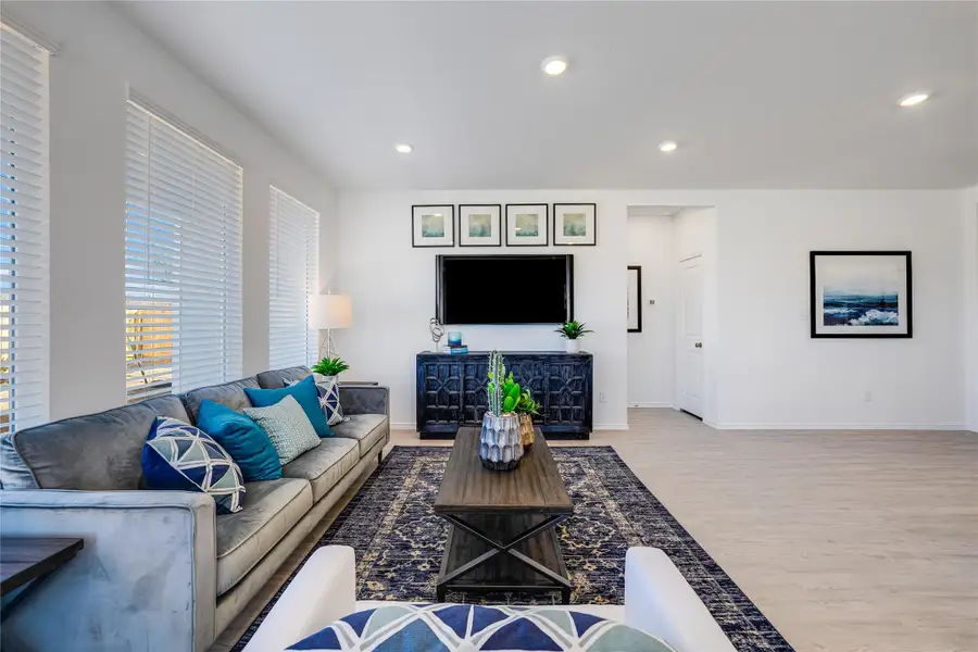 Living area with wood finished floors and recessed lighting