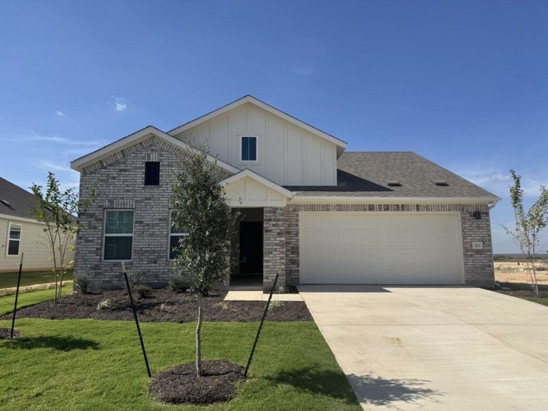 View of front of home with brick siding, board and batten siding, concrete driveway, a front lawn, and a garage View of front of home with brick siding, board and batten siding, concrete driveway, a front lawn, and a garage