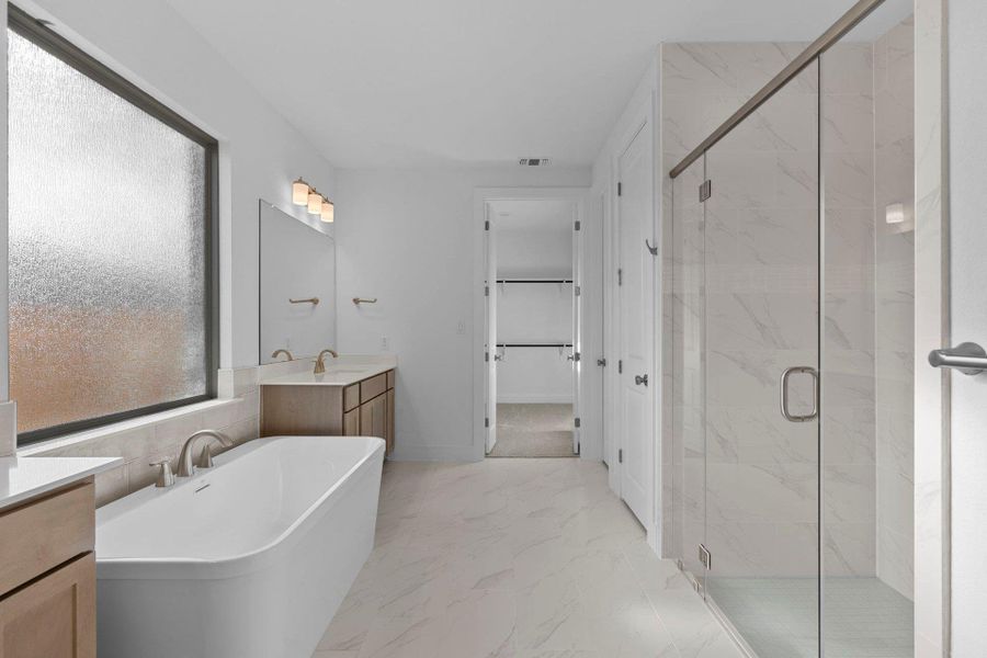 Primary Bath retreat with dual vanities, soaking tub & walk-in shower Primary Bath retreat with dual vanities, soaking tub & walk-in shower