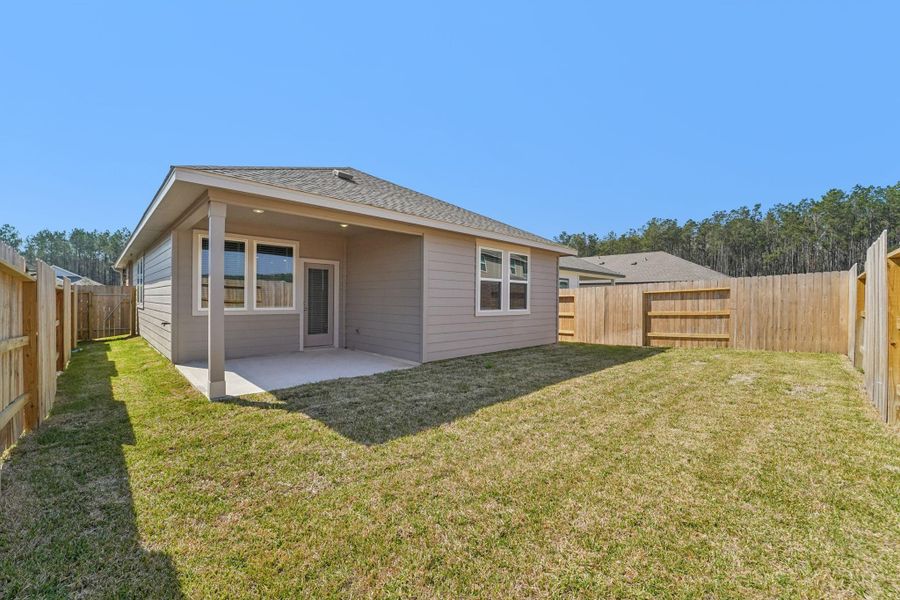 Exterior details and patio area of a home in Landing Meadows - Traditional Series, New Caney (Image 23).