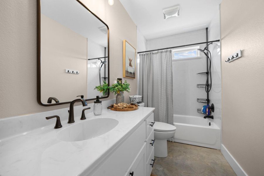 Bathroom featuring vanity and shower / tub combo