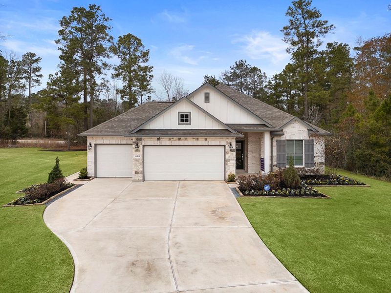 Front exterior of a new home in Oakwood Ranch, Willis, TX, highlighting curb appeal (Image 2). Front exterior of a new home in Oakwood Ranch, Willis, TX, highlighting curb appeal (Image 2).
