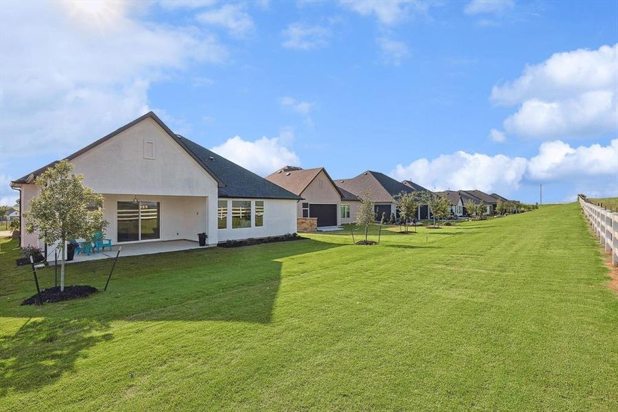 Back of house featuring a patio area and a lawn