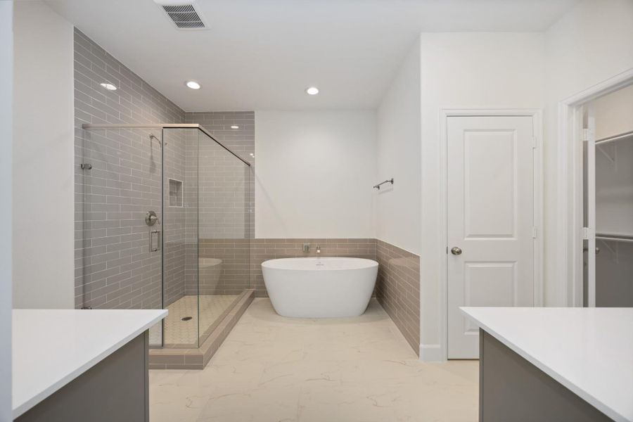 Soak away the stress of the day in your freestanding tub while your favorite playlist echoes off spa-white walls. This luxury en suite was made for unwinding.