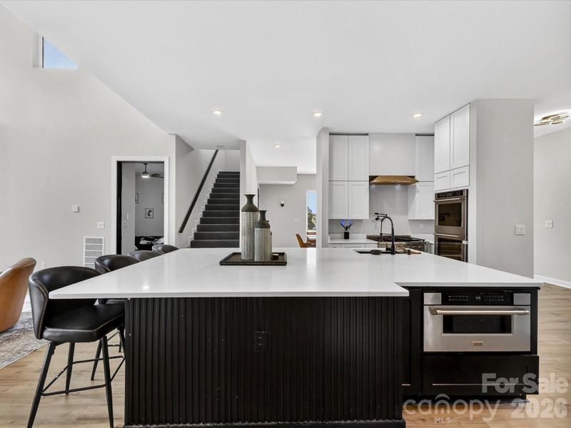Spacious contemporary kitchen with an oversized island, sleek white cabinetry, and modern finishes perfect for entertaining.