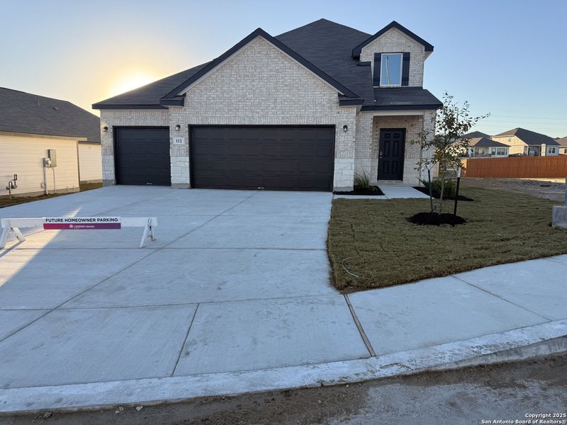 Front exterior of a new home in Hunters Ranch, San Antonio, TX, highlighting curb appeal (Image 2). Front exterior of a new home in Hunters Ranch, San Antonio, TX, highlighting curb appeal (Image 2).