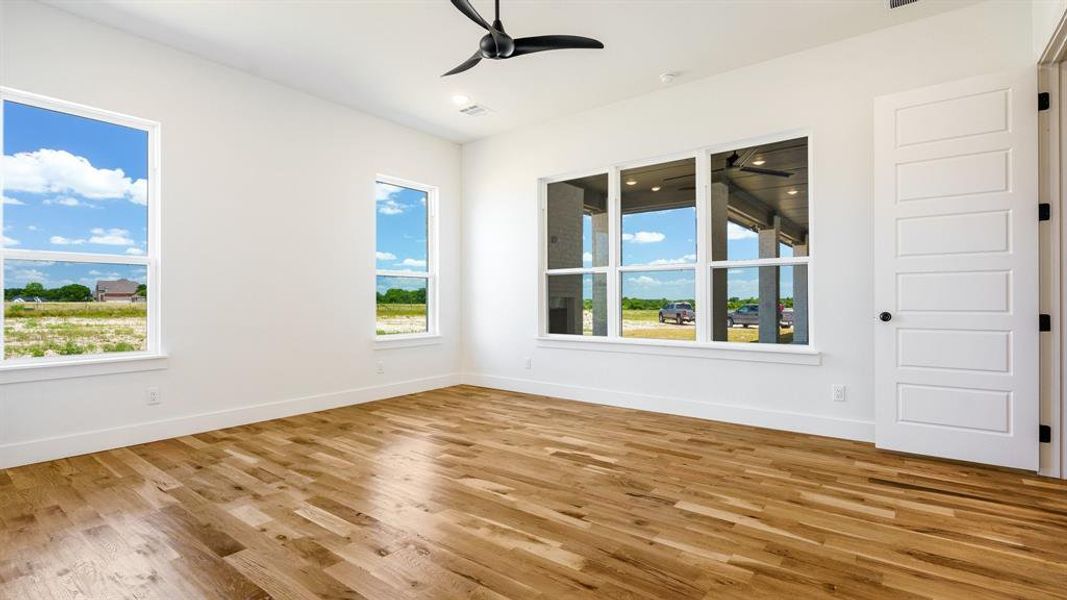 Unfurnished room featuring ceiling fan and light hardwood / wood-style flooring