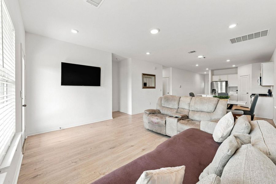 An open floorplan seamlessly connects the airy living area to the kitchen.