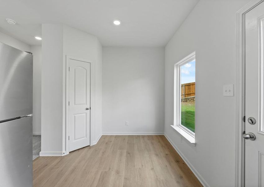 The dining room sits right off of the kitchen and has a large window.