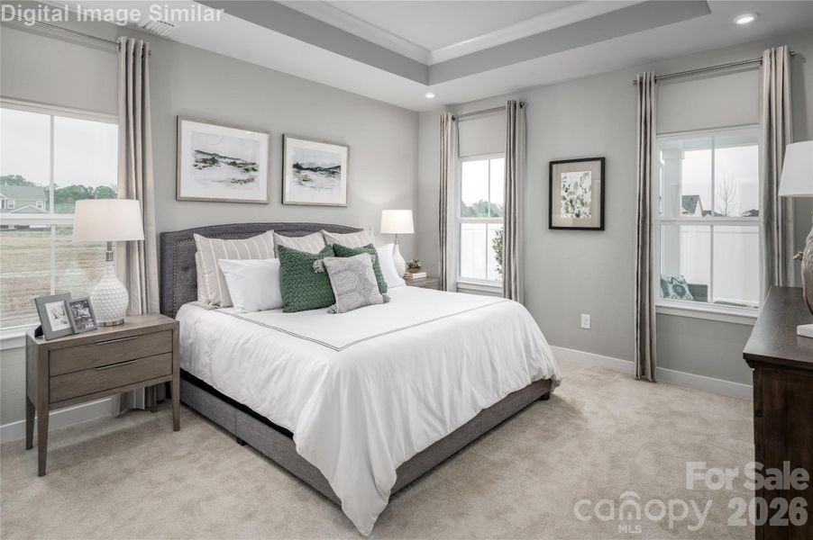 Retreat to your dream sanctuary—this cozy primary bedroom is a light-filled haven with walls of windows that welcome the sun. A stunning tray ceiling adds architectural charm, while its main-level location offers everyday ease. Wake up inspired, unwind in style, and let comfort wrap around you like a warm hug.