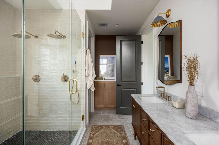 Elegant stone counters and a spacious glass-enclosed shower highlight this refined bathroom. Elegant stone counters and a spacious glass-enclosed shower highlight this refined bathroom.